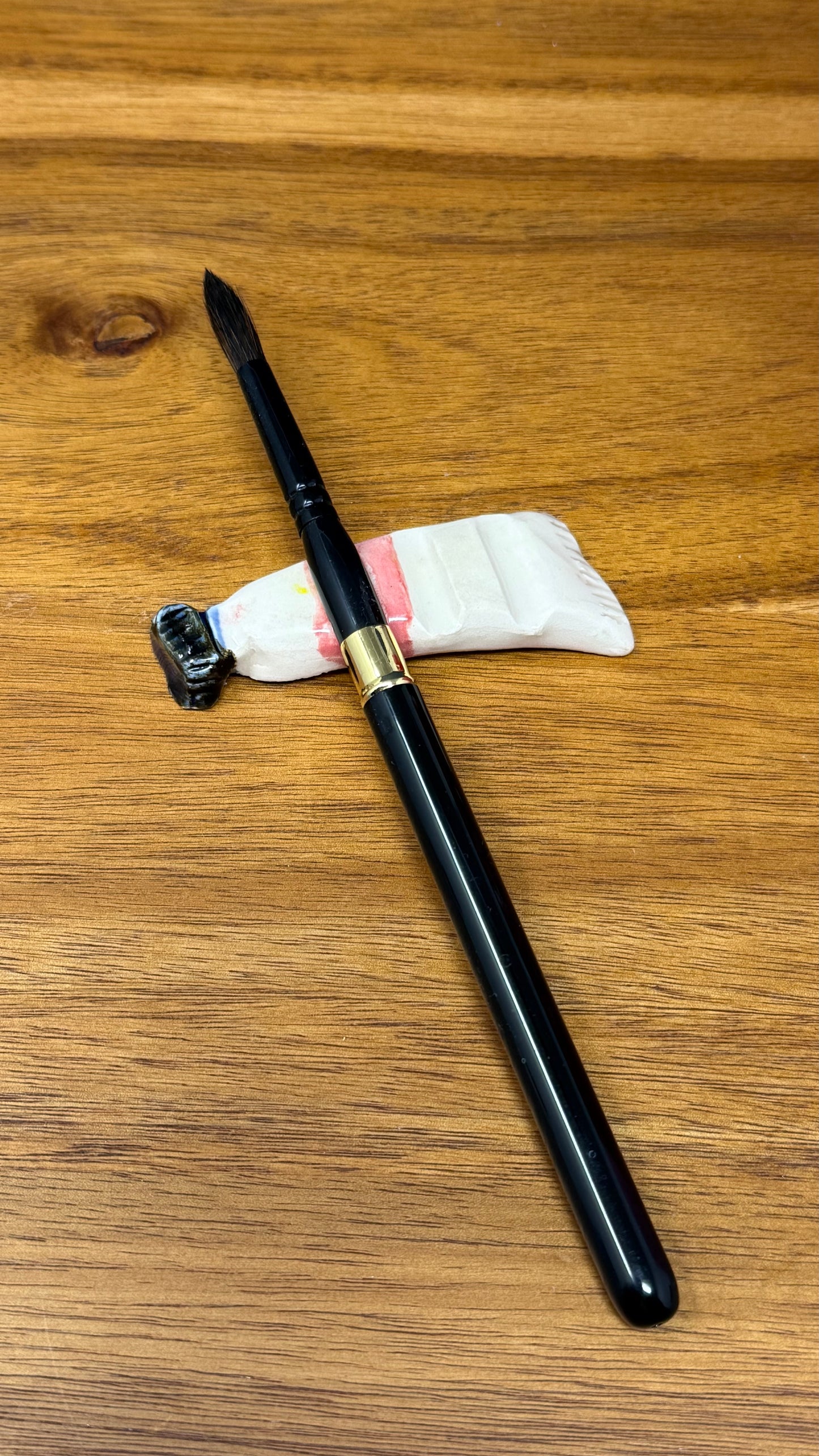 Paint tube brush rest
